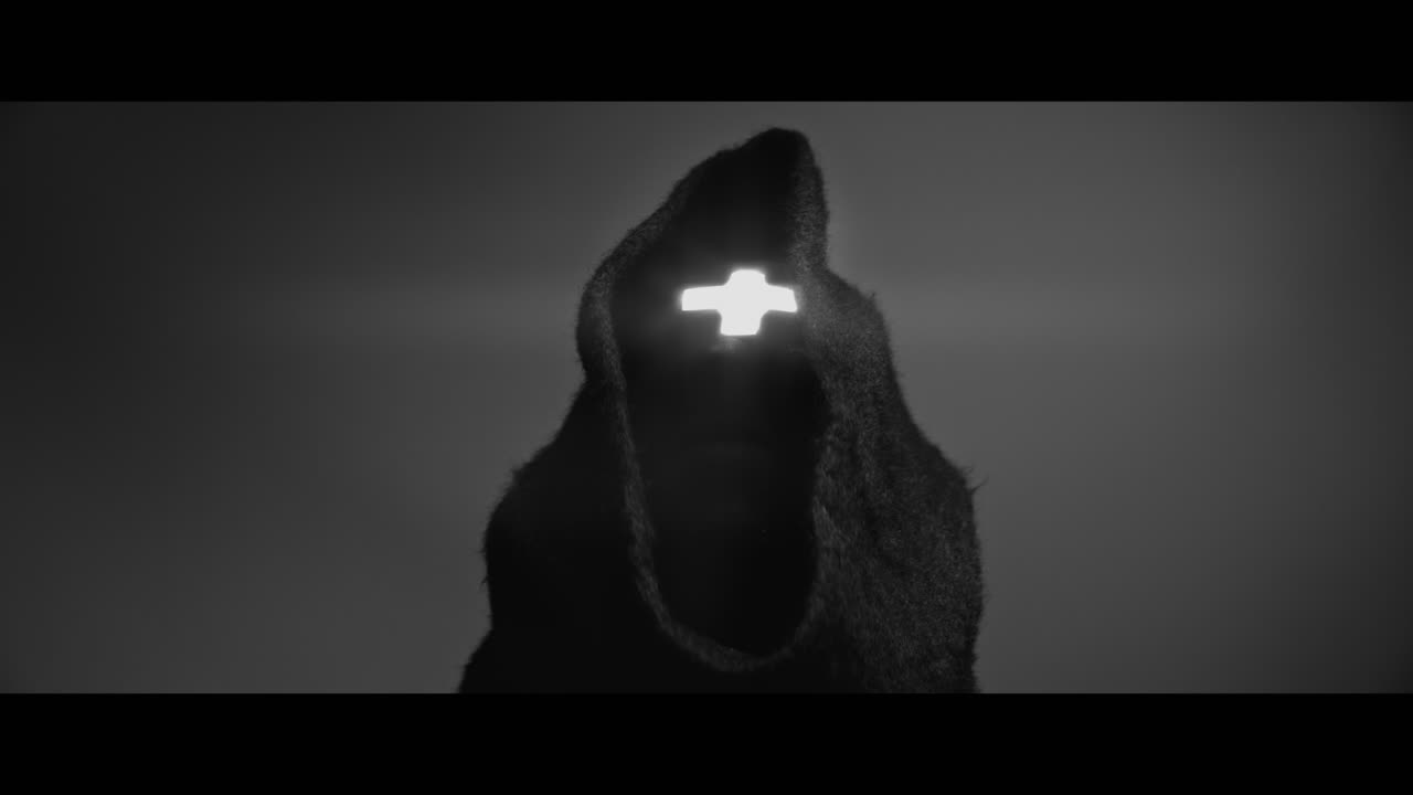 Masked man with cross of light glowing on his face moves his head up