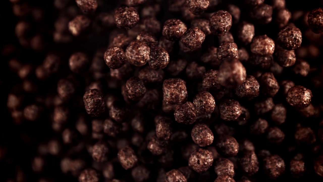 Slow Motion Chocolate Cereal Balls Falling on Dark Background
