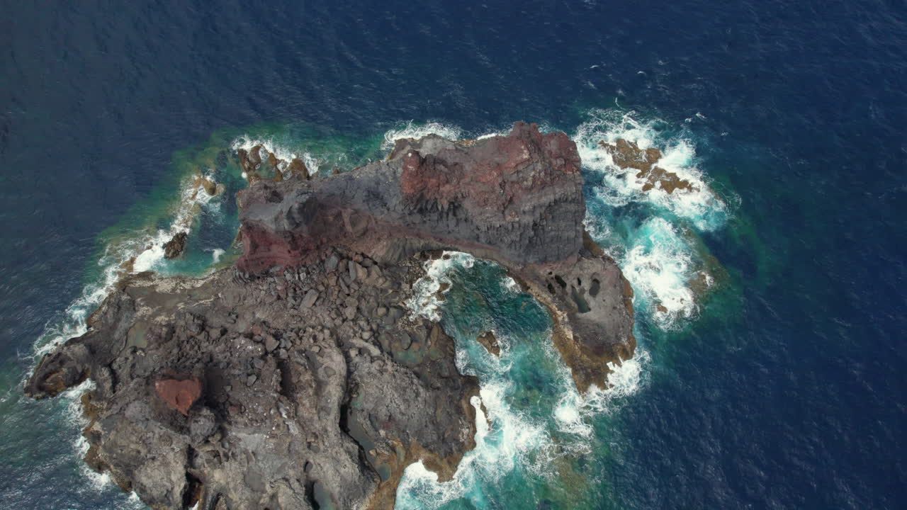 Aerial View of Volcanic Island with Crashing Waves