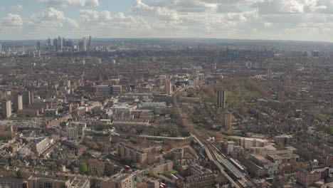 aerial shot over train tracks through east london