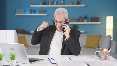 Hombre-Trabajador-De-Oficina-En-Casa-Recibiendo-Buenas-Noticias-Por-Teléfono.