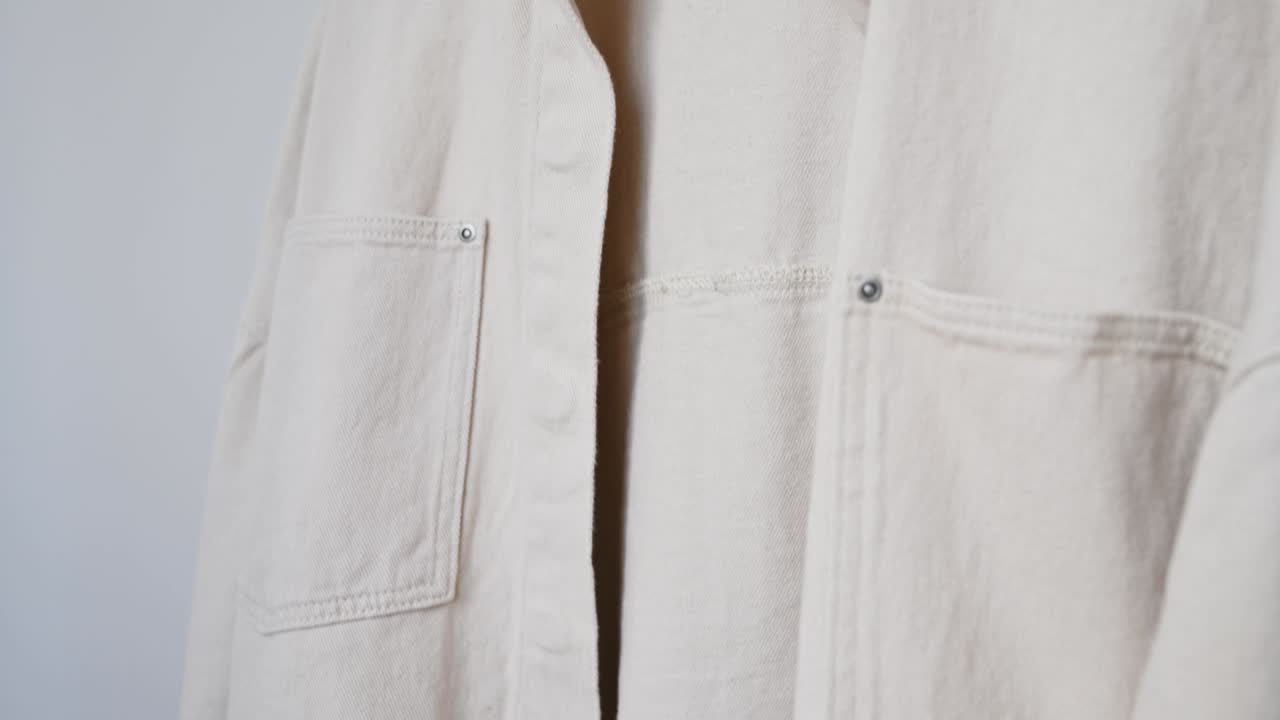 여성 패션 트렌디 장갑, 줄무 스웨트 셔츠, 베이지 청바지 셔트, 색 목조 에 재은 색 벽에 대한 랙에 매달려 있습니다. 미니멀리즘 의류 개념, 상점 광고 판매 쇼핑