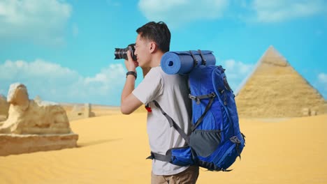 traveler taking photos in front of pyramids