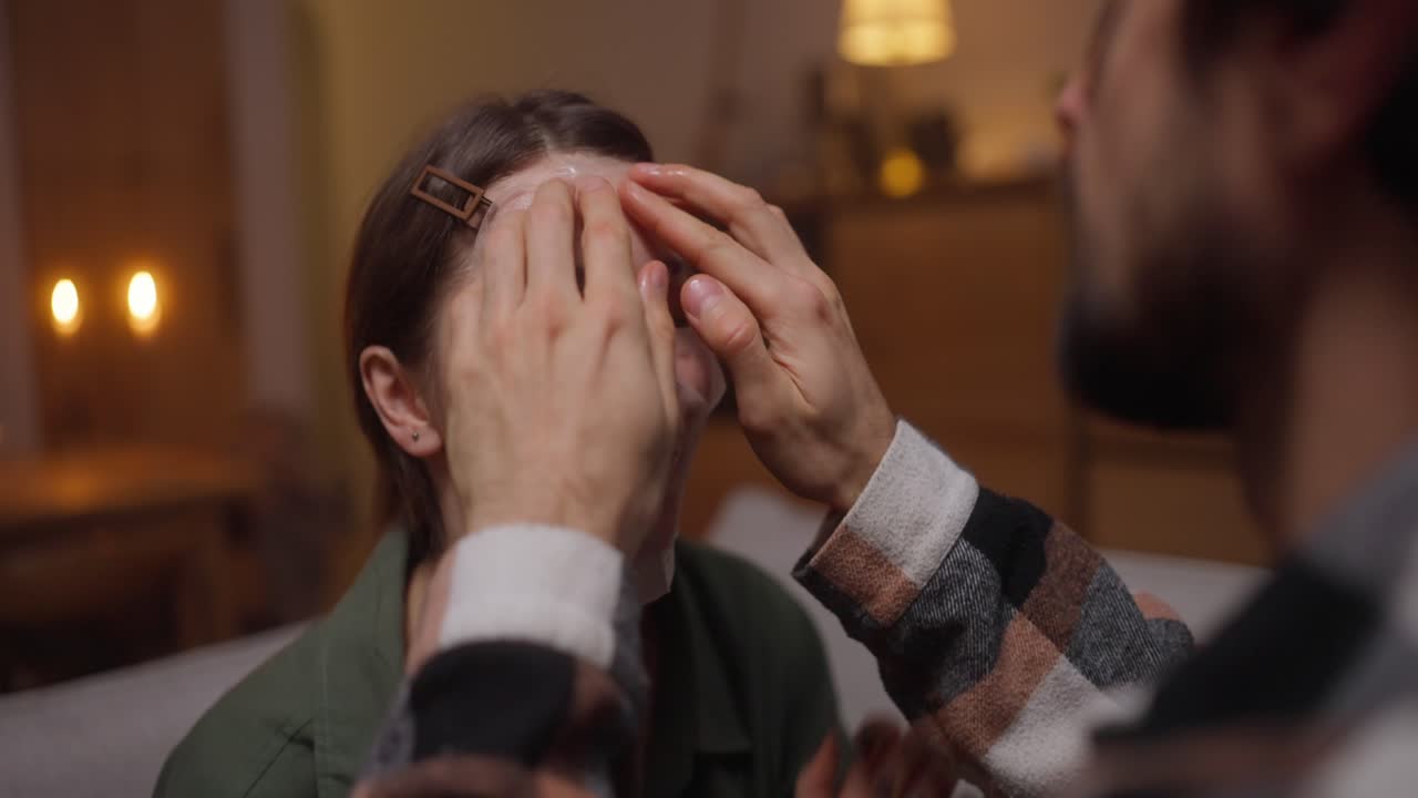 집에서 얼굴 마스크를 착용하는 부부