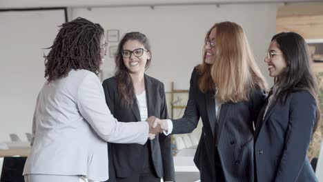 Mujeres-Empresarias-Felices-Saludándose-En-La-Oficina