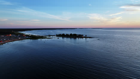 AERIAL:-Keskuskari-island,-sunny-summer-evening-in-Kalajoki-dunes,-Finland