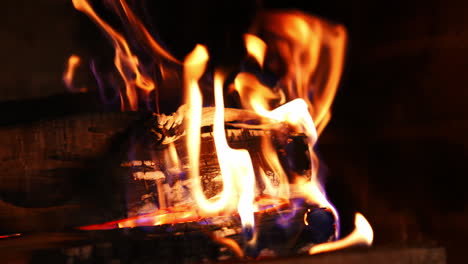 bright flame of burning fireplace. close up shot of warm cozy burning fire in a brick fireplace