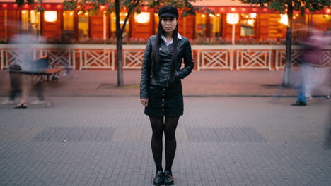 woman in a black leather jacket and skirt