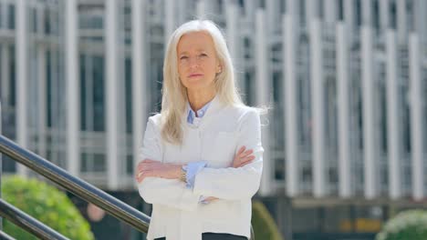 a confident senior medical professional in a white coat outdoors