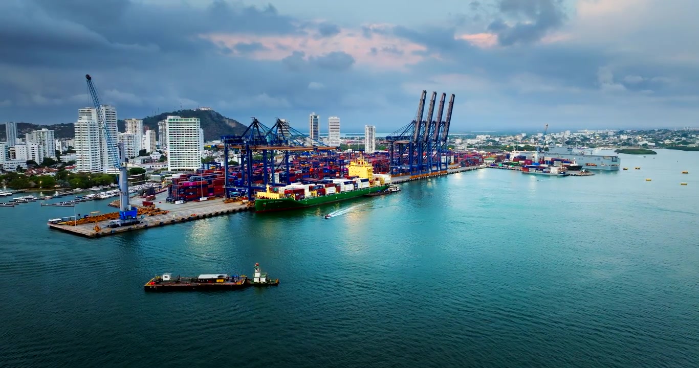 Drone establisher view of Cartagena port with container ship docked under cranes