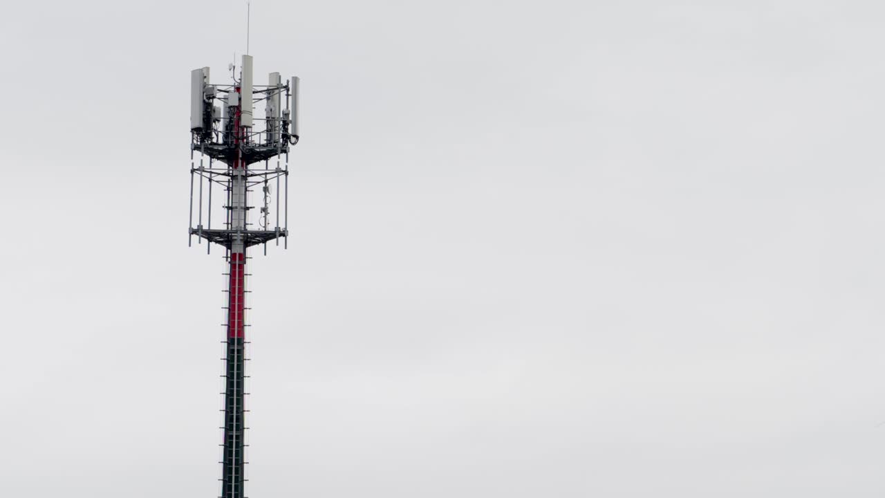 Telecommunication tower against a clear sky in an open setting