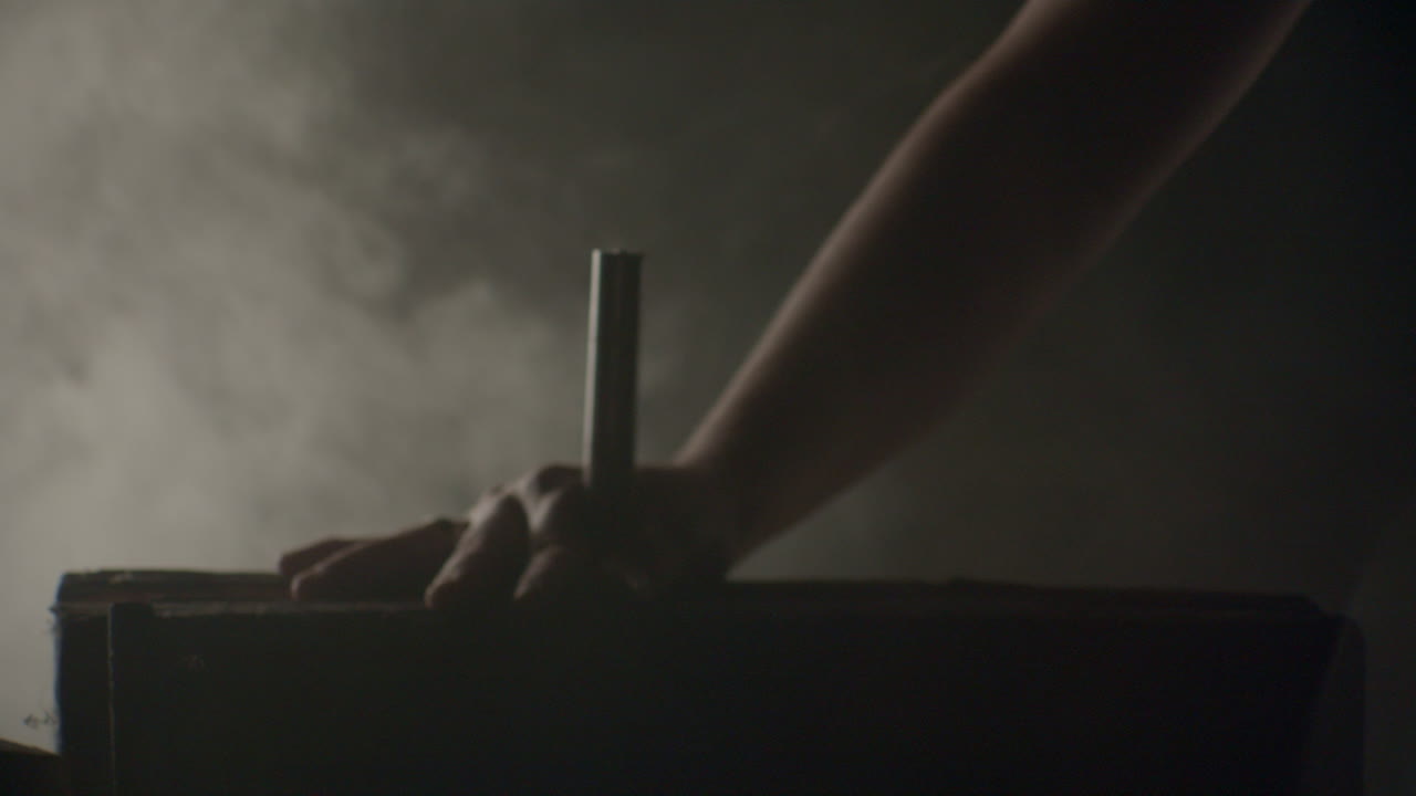 Hammer hitting a big nail in a dramatic misty ambience