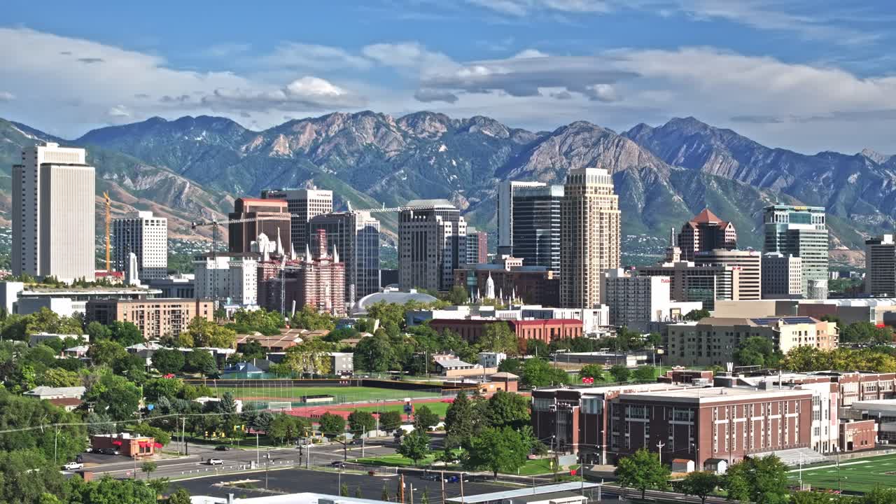 Aerial Shot over streets from Salt Lake City and Wasatch Mountains in the background