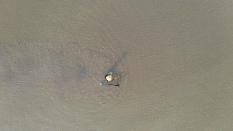 fisherman using a traditional fishing net