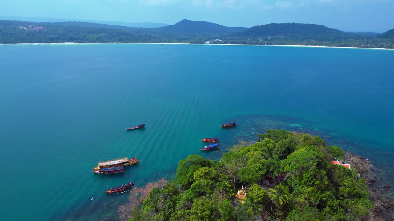 Tourist boats surrounding tropical Koh Toch Island near Sihanoukville, Cambodia. Perfect aerial view flight overflight flyover drone