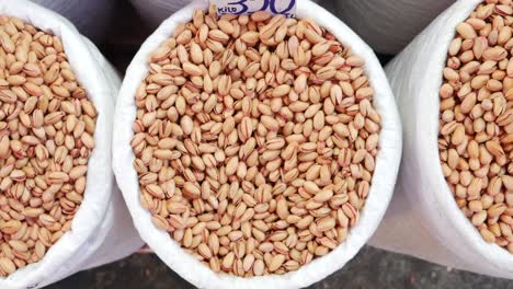 close-up of pistachios in bags at a market