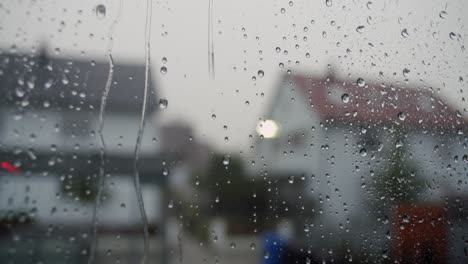 Close-up-of-raindrops-hitting-a-window-during-a-thunderstorm