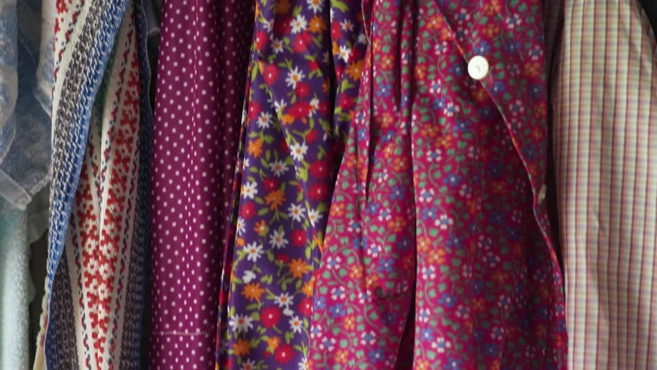 Traditional village woman's clothes hanging on a rustic wall