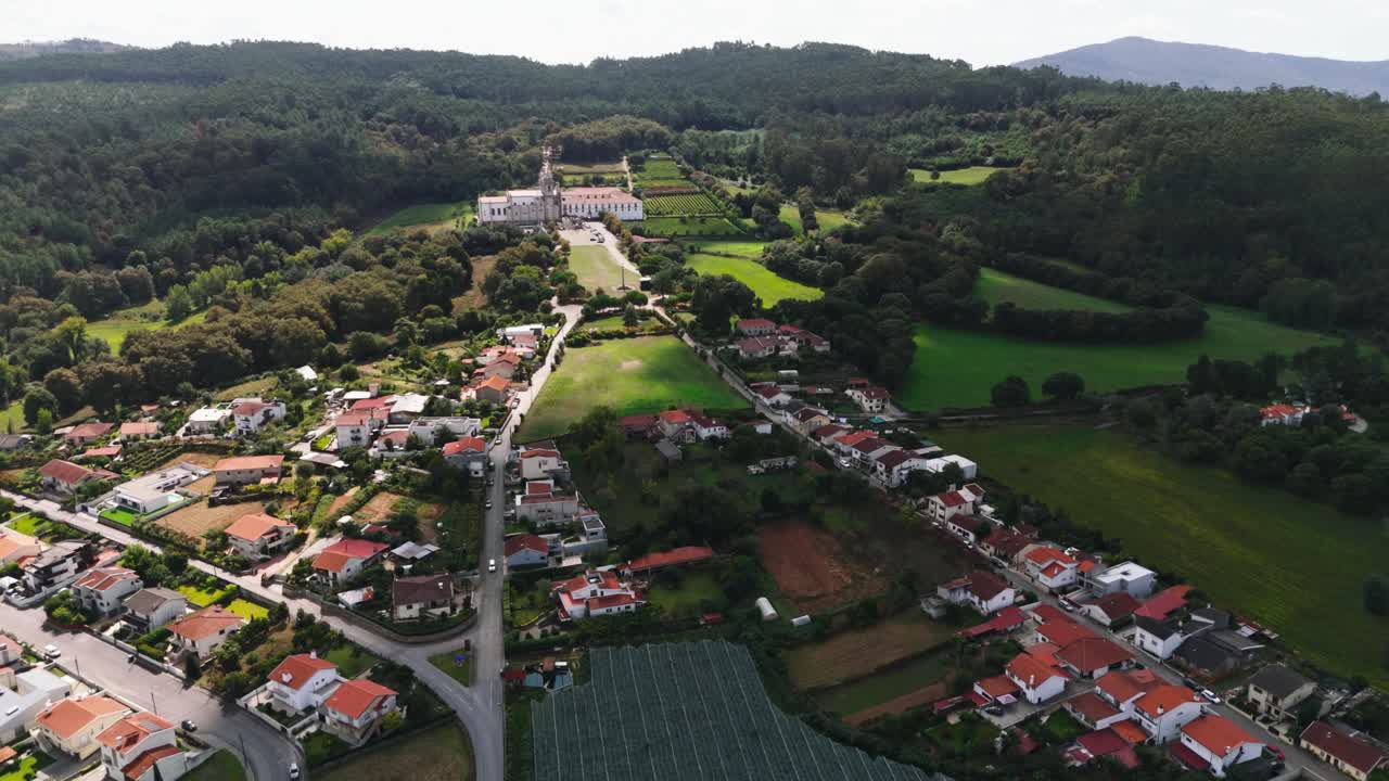 Drone view of rural village and green hills surrounding Tibães Monastery