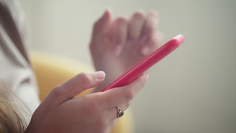 woman using a red smartphone