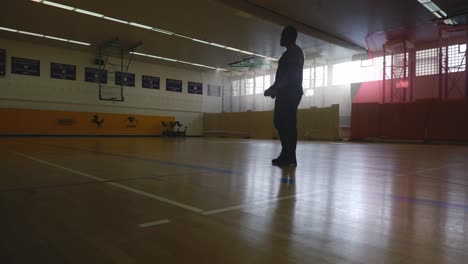 Male-Slowly-Looking-Around-and-Walking-Off---Strong-Athletic-Muscular-Black-Man-Standing-On-Basketball-Court-Looking-Around-In-4K