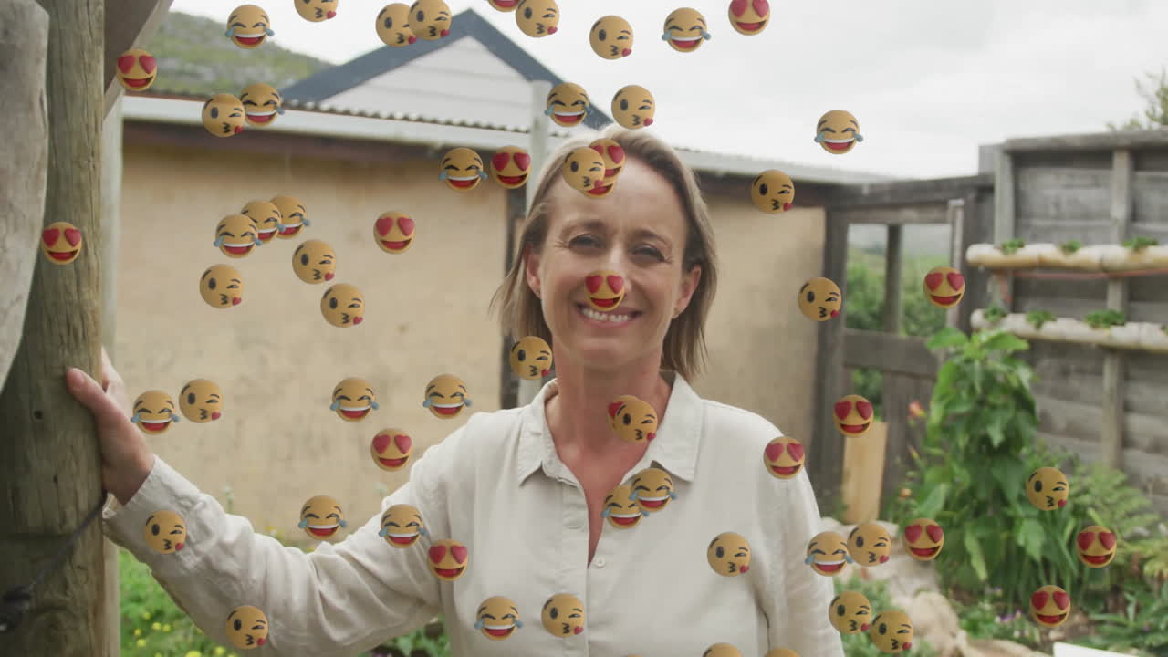 woman leaning on wooden post in garden, showcasing floating emojis for marketing