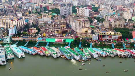 aerial of vibrantly colored ferry ships docked on the buriganga river