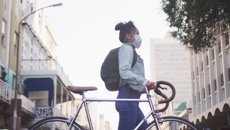 woman wearing medical coronavirus mask walking on the street