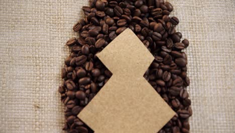 christmas tree made of cardboard arranged on coffee beans 4k