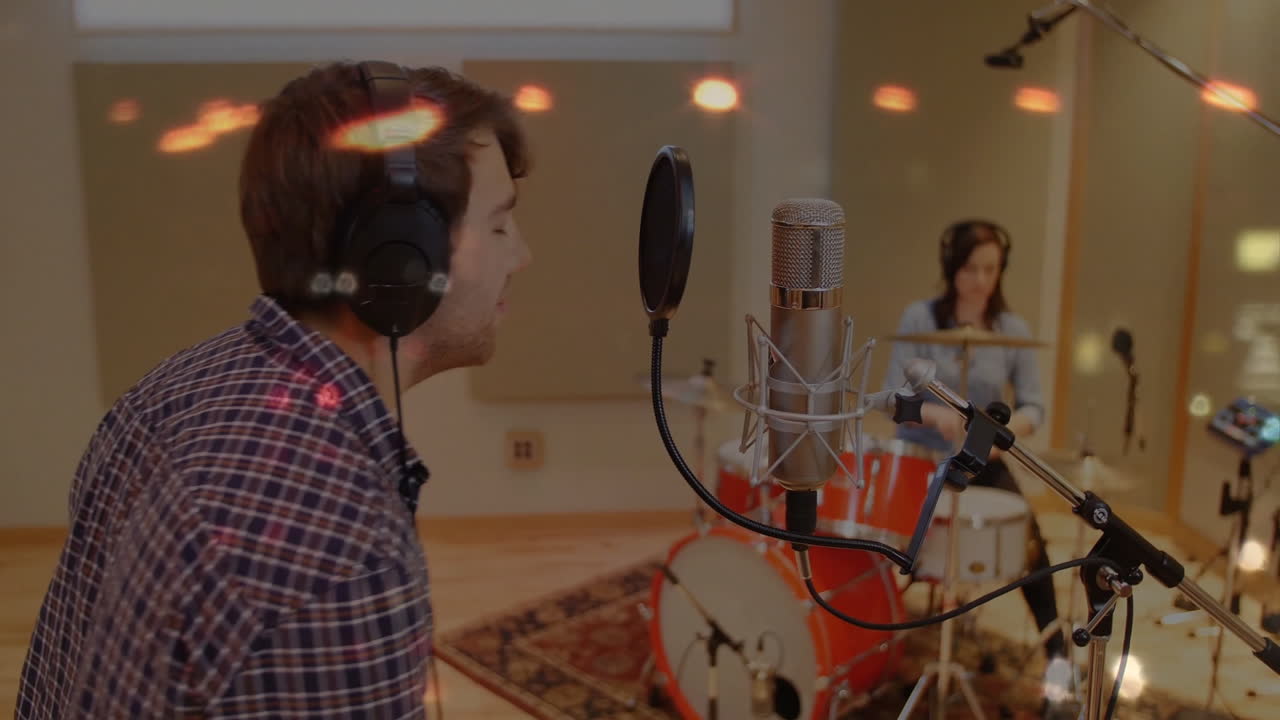 Male vocalist and drummer performing recording session, showing microphone icon and audio waveforms