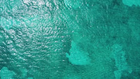 Bird-eye aerial above the turquoise blue waters of the Caribbean Sea, the aerial perspective captures the stunning vista near Cancun's hotel zone in Mexico