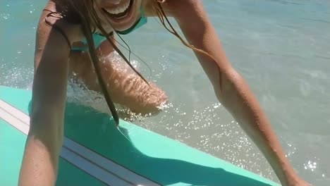 woman is surfing in sea