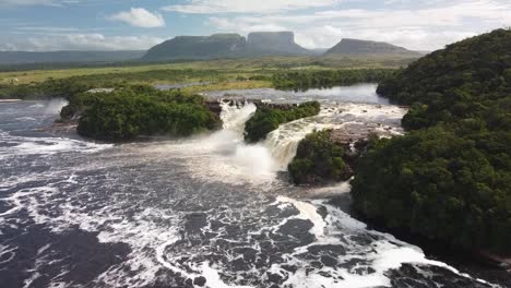 Aerial-view-of-waterfalls-in-the-Canaima-Lagoon,-Amazon-rainforest,-Venezuela,-zoom-out