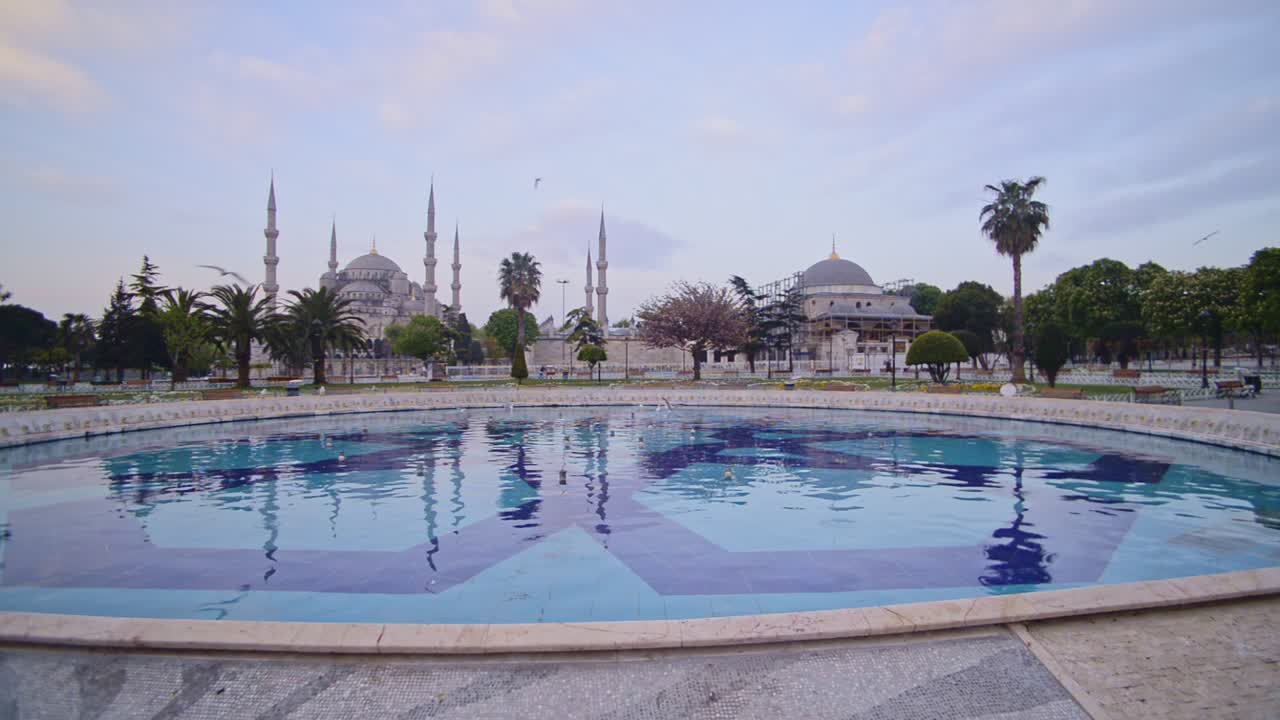 Landscape view of the Blue Mosque, with birds flying, Istanbul, Turkey, at dusk
