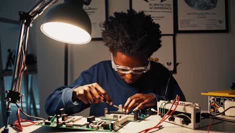 young person working on electronics