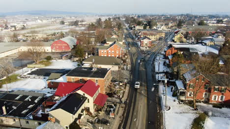 aerial downtown intercourse during snowfall with street traffic