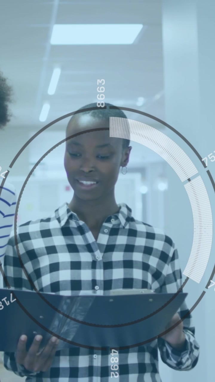 Animation of round scanner over two diverse female colleagues discussing while walking at office
