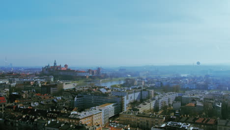 Drohnenaufnahmen-Einer-Stadt-Mit-Einer-Burg-Im-Hintergrund-Und-Einem-Ballon-Am-Himmel