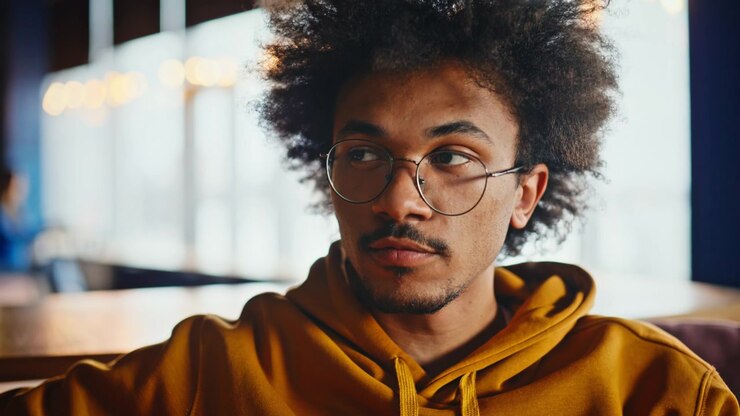 Close up hands holding coffee mug. Thoughtful man cafe lounge daydreaming.