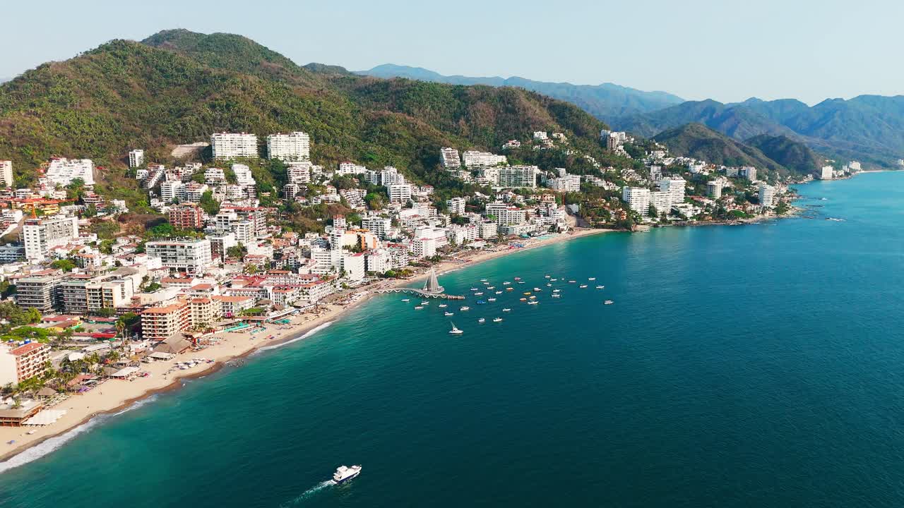 International tourist area in Los Muertos beach with its emblematic pier, clear water scenery