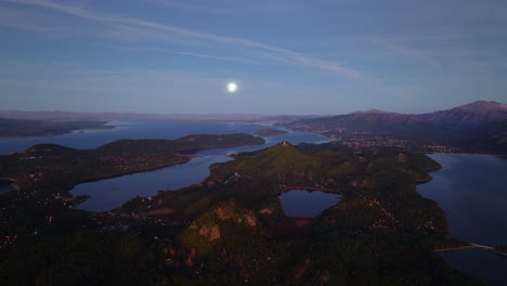 aerial view of lake nahuel huapi near bariloche, rio negro, argentina in the evening with the full moon on the horizon