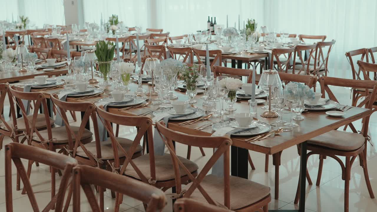 Beautifully arranged wooden tables with floral decor and glassware