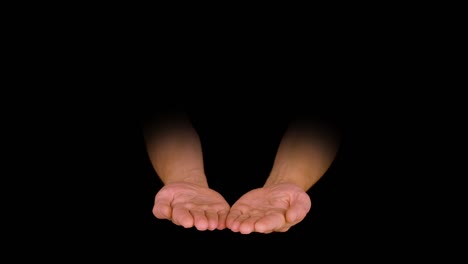 two empty male palm hand holding something on black background