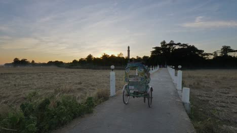 rickshaw riding into the sunset in a bangladeshi village