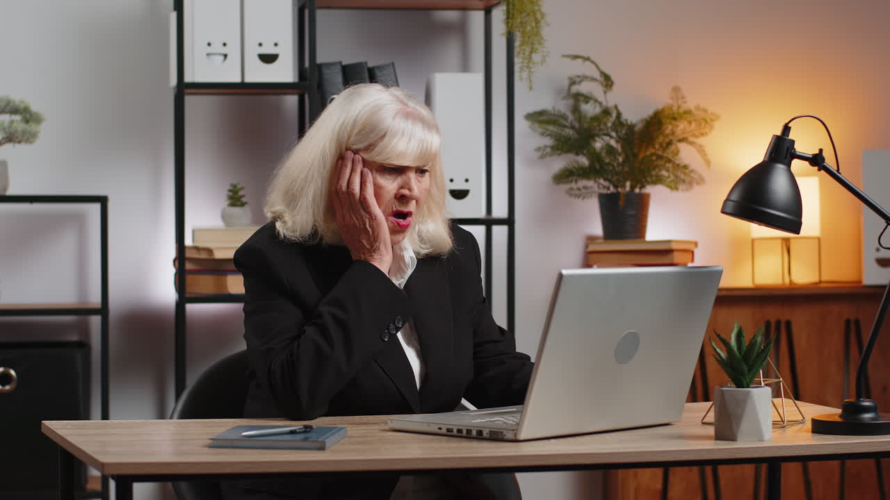 Elderly employer freelancer using laptop working at home office having nervous breakdown at work