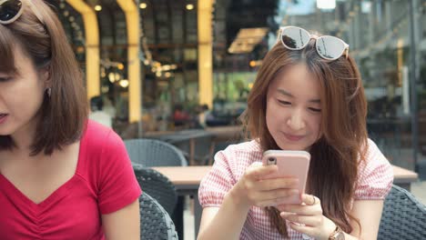 beautiful asian girl chatting with friends at lunch time