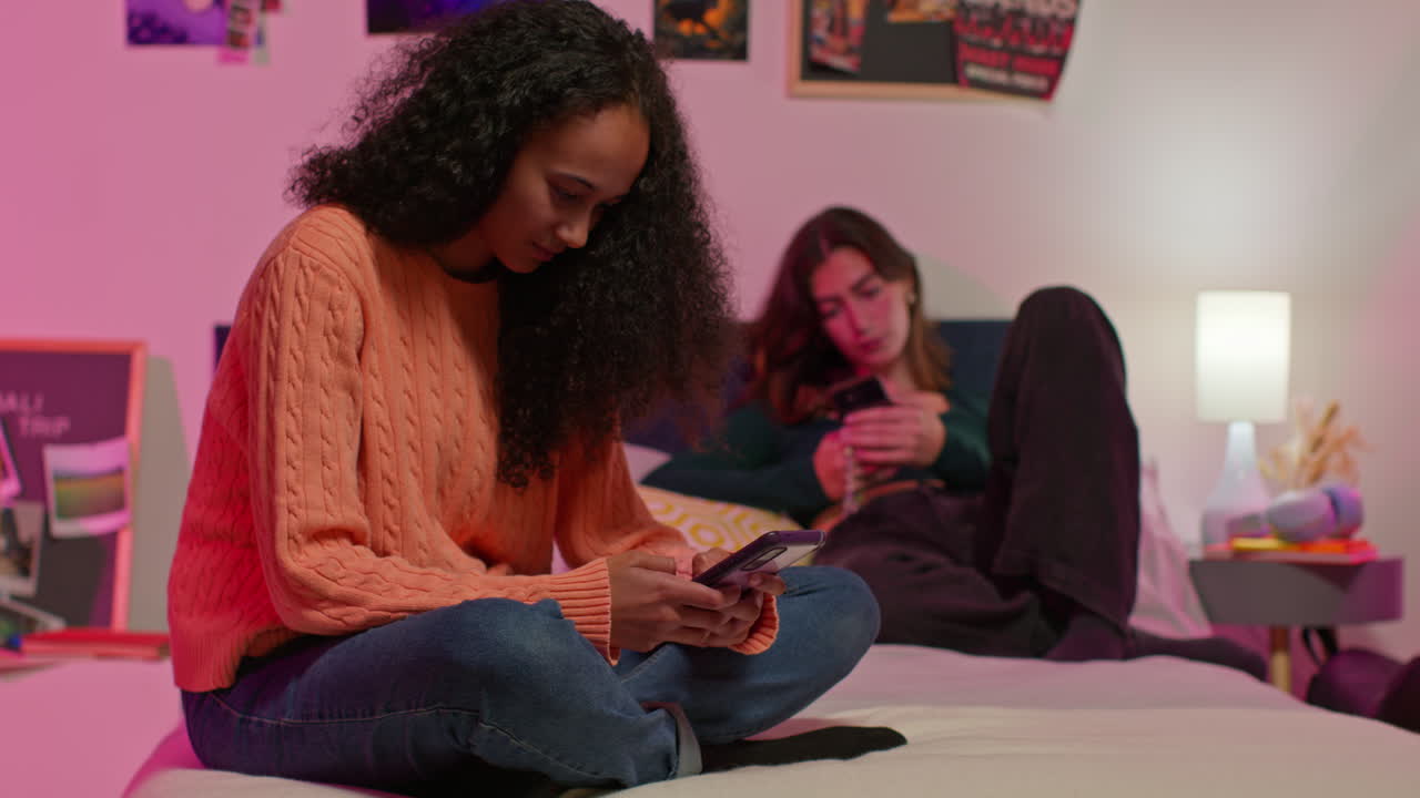 Teenage Girls on Phones in Bedroom