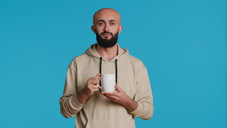 muslim person enjoying fresh caffeine aroma in studio