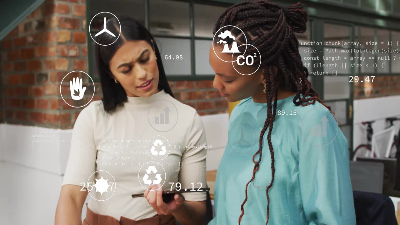 Women tapping tablet in office, updating eco icons and code, discussing analytics, nodding solutio