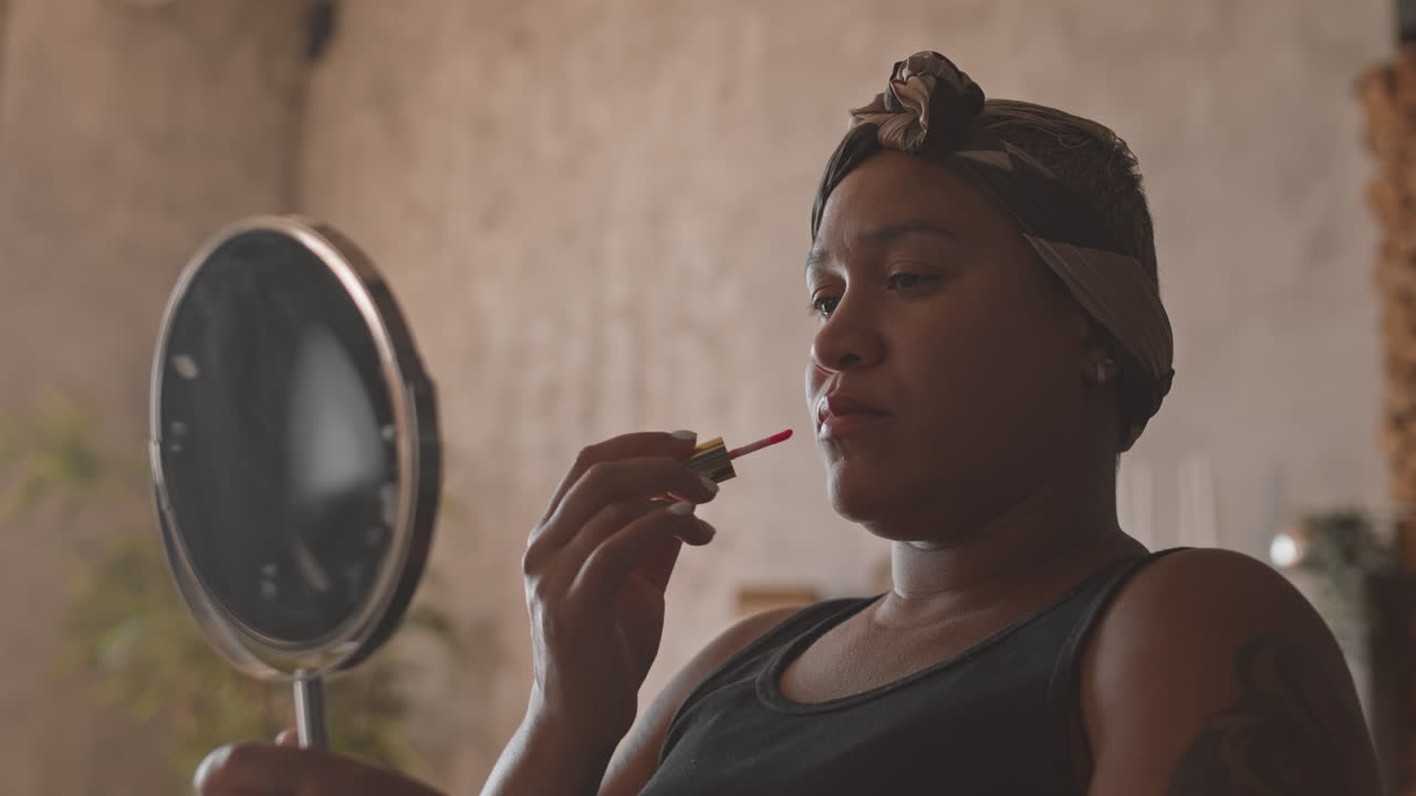 Multiethnic Woman Applying Lip Gloss